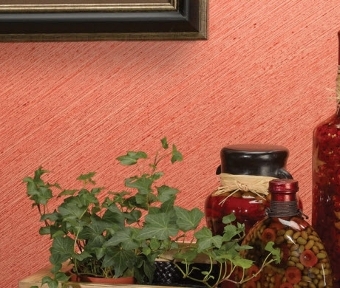 Decor pieces on a table beside a diagonal red wall pattern