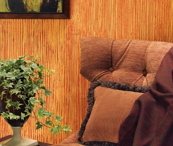 Top of chair in front of vertical line styled orange wall